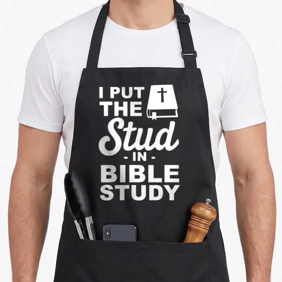 Funny stud bible study apron - White I put the stud in bible study text and bible icon on black fabric — shown on a black cotton canvas apron against a white background
