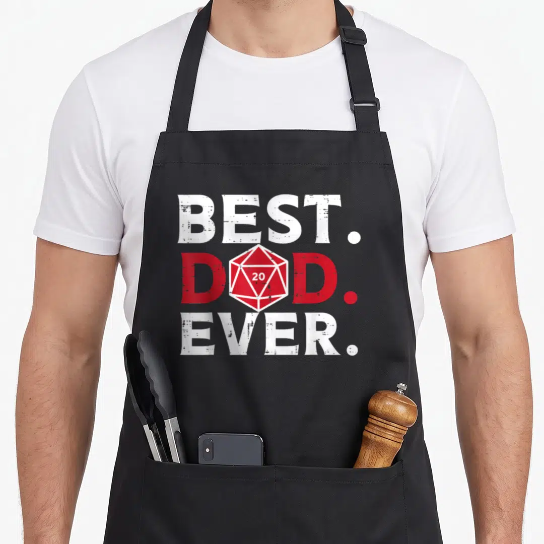 Rpg grill daddy apron - Red d20 die replaces A in DAD between white BEST and EVER text — shown on a black cotton canvas apron against a white background