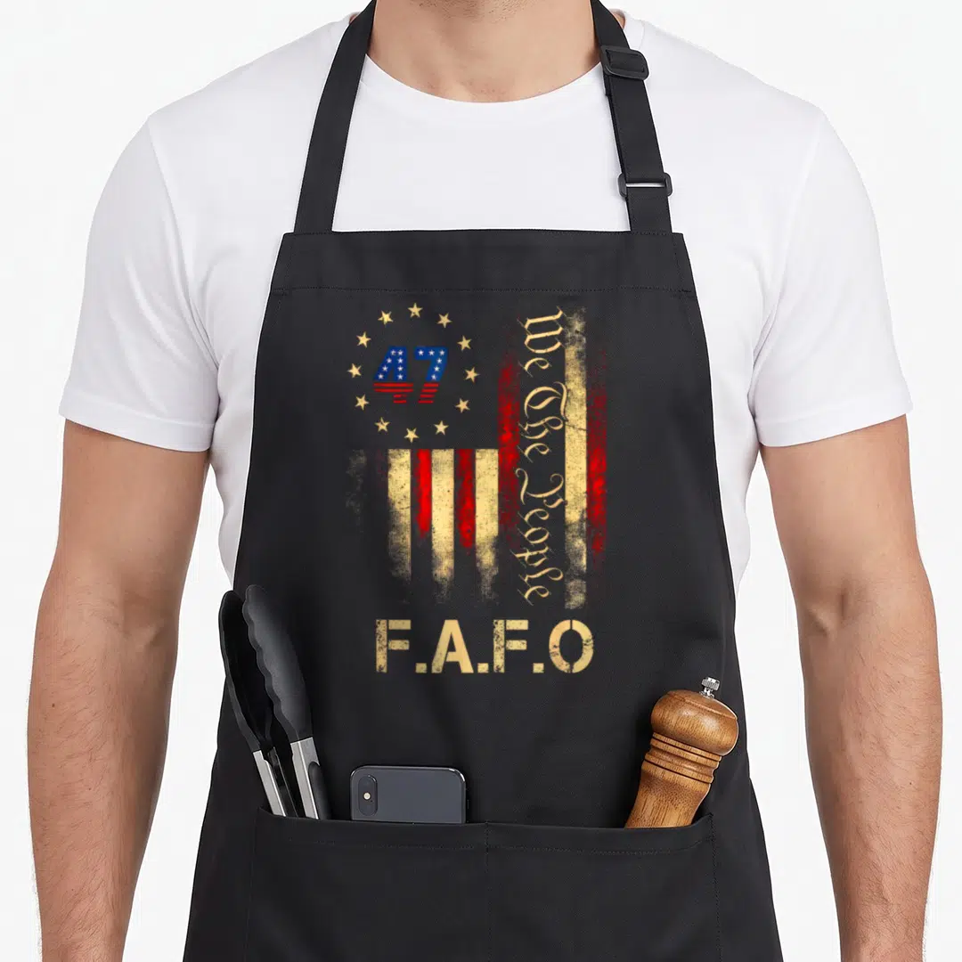Fafo american flag apron - Distressed US flag with 47 in stars, vertical We The People text, and F.A.F.O at bottom — shown on a black cotton canvas apron against a white background