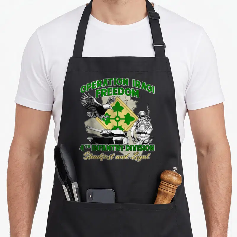 4th operation apron - Operation Iraqi Freedom text with 4th Infantry Division eagle tank soldier emblem in green — shown on a black cotton canvas apron against a white background