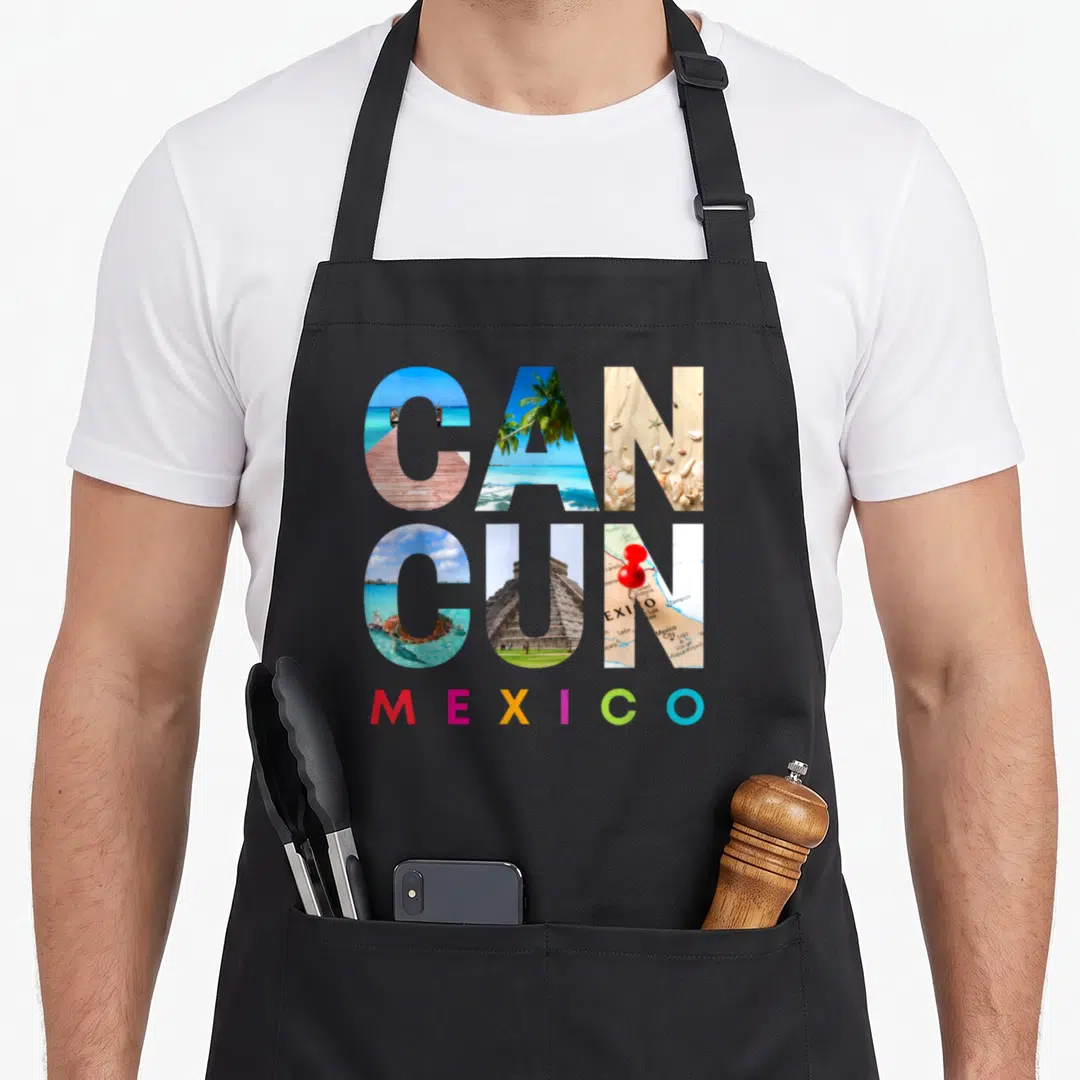 Cancun mexico apron - CANCUN photo letters showing pier turtle pyramid map, MEXICO in red yellow green blue — shown on a black cotton canvas apron against a white background