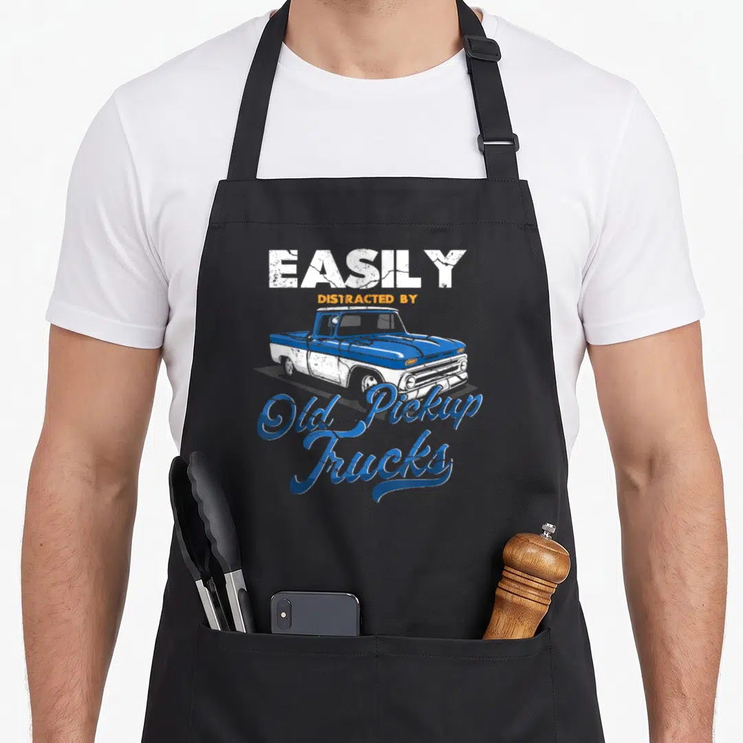 Pickup car truck apron - Distressed blue and white vintage truck illustration with EASILY DISTRACTED BY Old Pickup — shown on a black cotton canvas apron against a white background