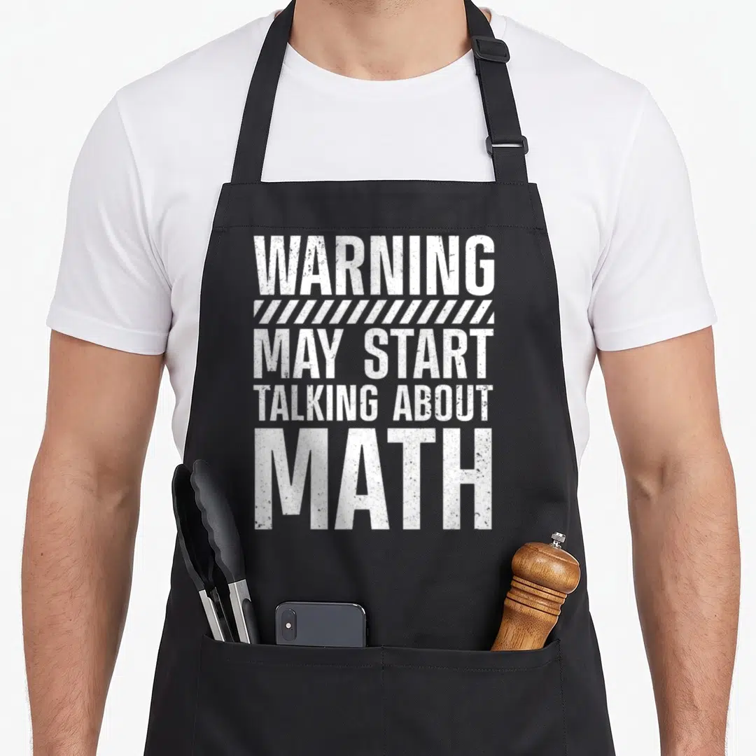 Mathematic math teacher apron - White distressed text reading WARNING MAY START TALKING ABOUT MATH with diagonal stripe — shown on a black cotton canvas apron against a white background