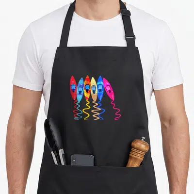 Outdoor colorful aprons - Six cartoon kayaks in red blue orange yellow pink with wavy lines below — shown on a black cotton canvas apron against a white background