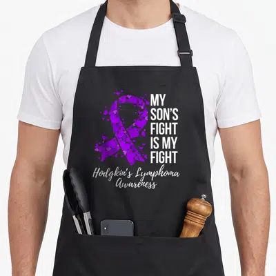 Son lymphoma awareness apron - Purple heart ribbon and My Son's Fight Is My Fight text for Hodgkin's Lymphoma — shown on a black cotton canvas apron against a white background