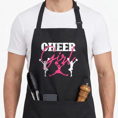 Cheering cheerleading apron - Distressed white and pink graphic with CHEER Girl text and three cheerleader silhouettes — shown on a black cotton canvas apron against a white background