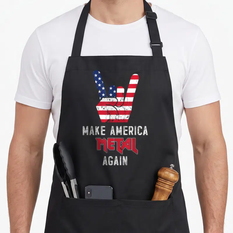 Metal rock heavy apron - Distressed hand gesture with US flag pattern above stacked text Make America Metal Again — shown on a black cotton canvas apron against a white background