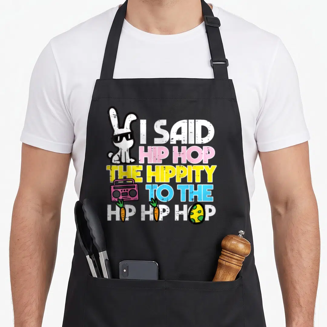 Hippity hip aprons - Bunny sunglasses text I SAID HIP HOP boombox two carrots easter egg — shown on a black cotton canvas apron against a white background