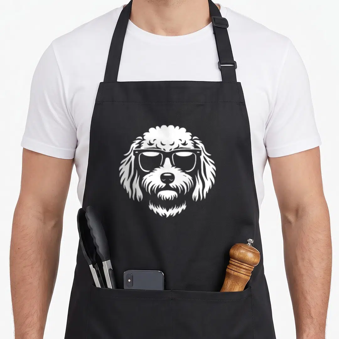 Cavapoo sunglass dog apron - White line art dog face with sunglasses on black apron — shown on a black cotton canvas apron against a white background