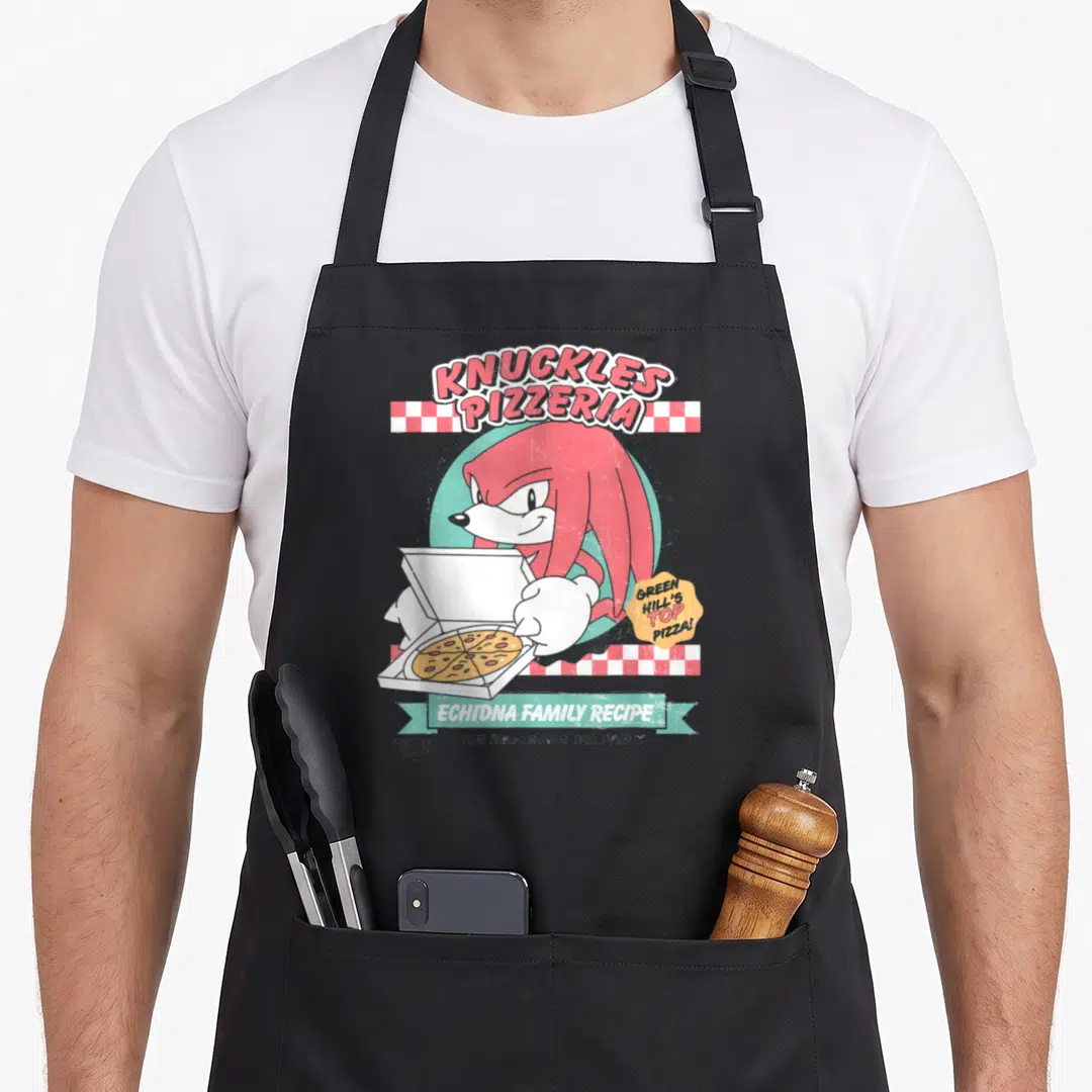 Knuckle crazy hedgehog man apron - Cartoon echidna holding pizza box with red and white checkered stripes and arched — shown on a black cotton canvas apron against a white background