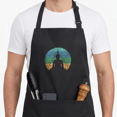 Buddha yoga dad apron - Grey sitting Buddha silhouette over distressed striped circle with blue star outline — shown on a black cotton canvas apron against a white background