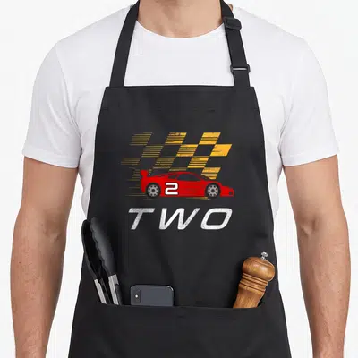 Driver 2nd apron - Red race car with yellow speed lines and white TWO text — shown on a black cotton canvas apron against a white background