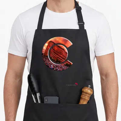 Rock state colorado apron - Letter C filled with red rock photo and crowd scene — shown on a black cotton canvas apron against a white background