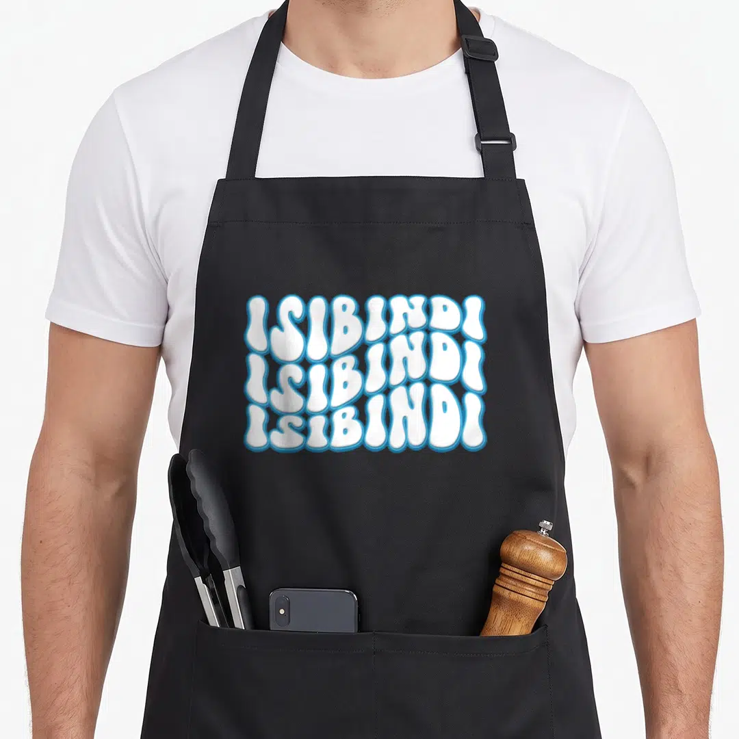 Cute school apron - Stacked white ISIBINDI text with blue outlines in wavy groovy typography — shown on a black cotton canvas apron against a white background