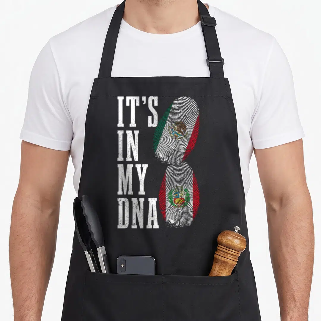 Peru mexico apron - IT'S IN MY DNA text next to two fingerprints filled with Mexican and Peruvian flag colors — shown on a black cotton canvas apron against a white background