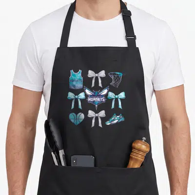 Charlotte bow apron - Charlotte Hornets logo surrounded by teal and purple bows, jersey, hoop, shoe, and heart — shown on a black cotton canvas apron against a white background