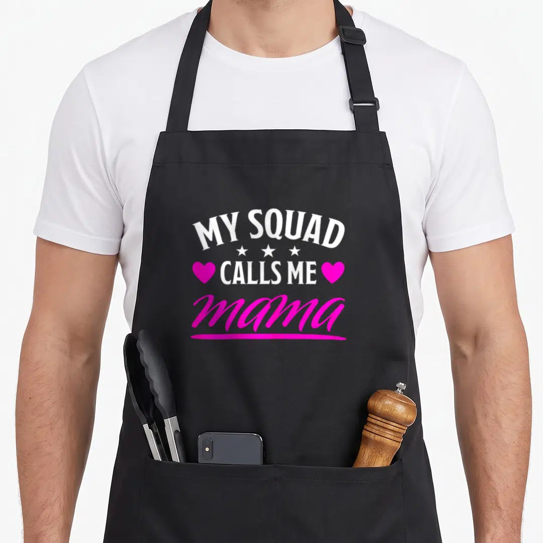 Family my mother's apron - My Squad Calls Me Mama text with stars and pink hearts — shown on a black cotton canvas apron against a white background