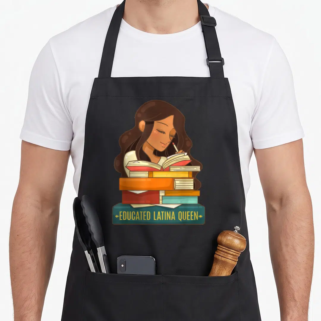Educated queen apron - Cartoon woman reading behind stacked books with banner text educated latina queen — shown on a black cotton canvas apron against a white background