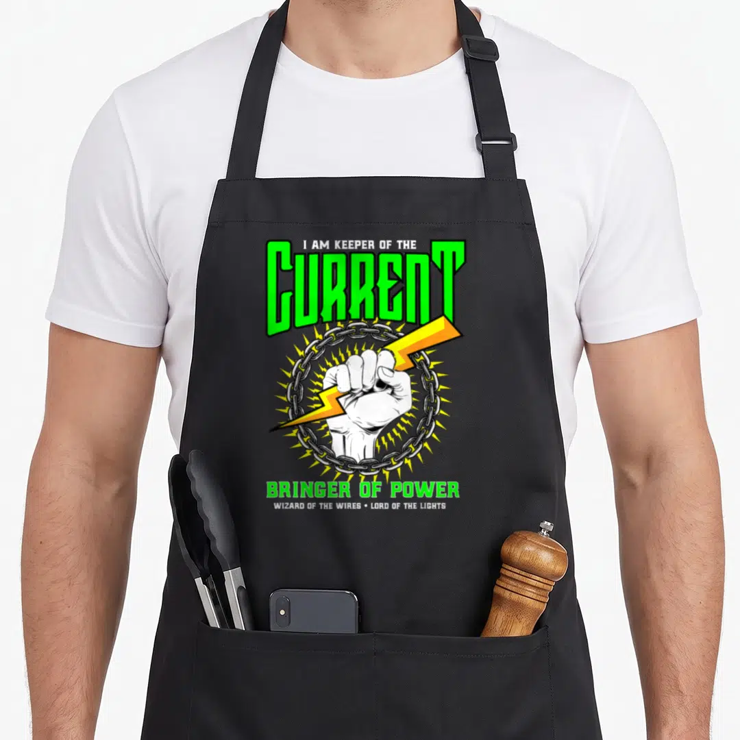 Electrical electrician apron - Fist clutching yellow lightning bolt in silver chain with green text I AM KEEPER — shown on a black cotton canvas apron against a white background