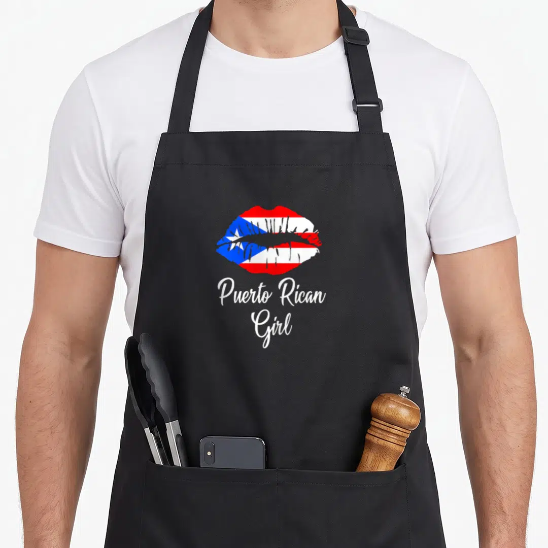 Lip pride apron - Lips filled with Puerto Rican flag pattern above white Puerto Rican Girl script text — shown on a black cotton canvas apron against a white background