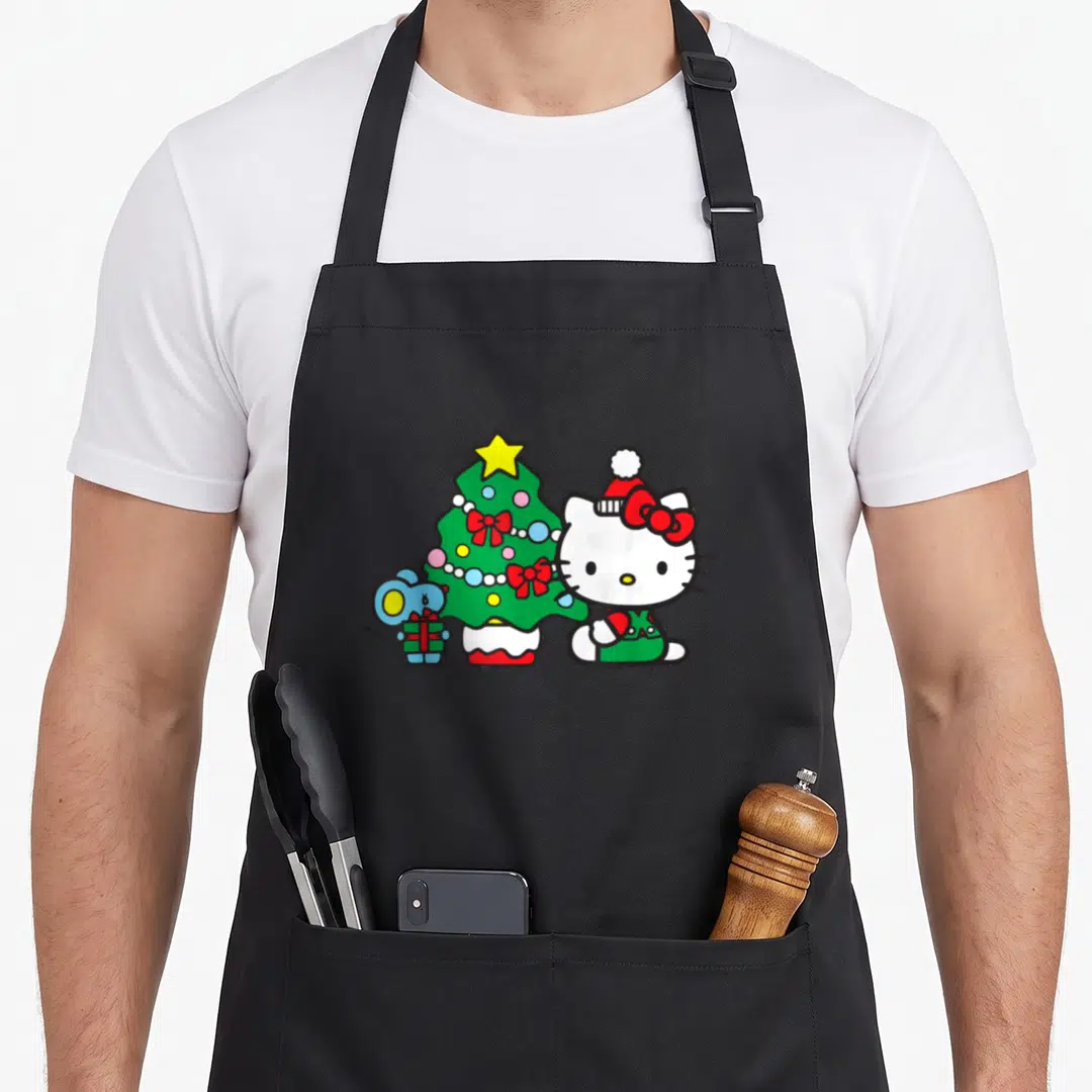 Funny christmas tree apron - Hello Kitty in Santa hat beside green Christmas tree and blue mouse holding gift — shown on a black cotton canvas apron against a white background
