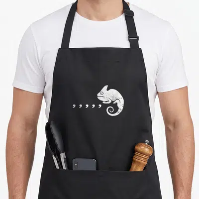 Pun 80s apron - White distressed chameleon with six quotation marks extending from mouth — shown on a black cotton canvas apron against a white background