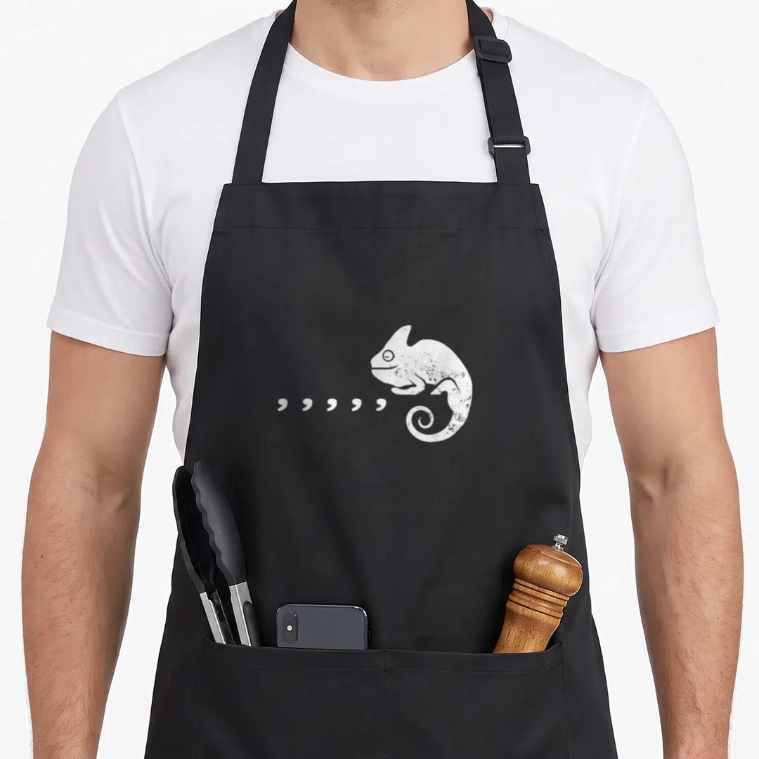 Pun 80s apron - White distressed chameleon with six quotation marks extending from mouth — shown on a black cotton canvas apron against a white background