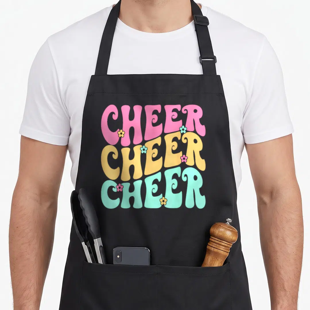 Practice cheer apron - Stacked CHEER text in pink yellow and mint green with small flowers — shown on a black cotton canvas apron against a white background