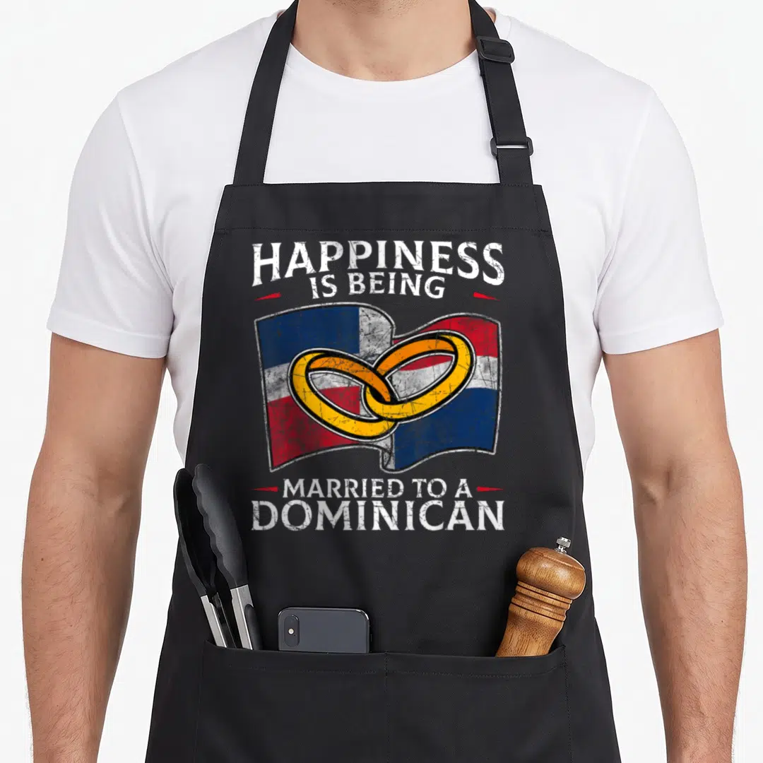 Republic heritage aprons - Two interlocking gold rings over a waving Dominican Republic flag with distressed text — shown on a black cotton canvas apron against a white background