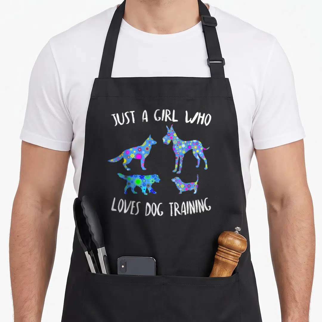 Vintage trainer dog training apron - Four blue dog silhouettes filled with colorful floral patterns and white text — shown on a black cotton canvas apron against a white background