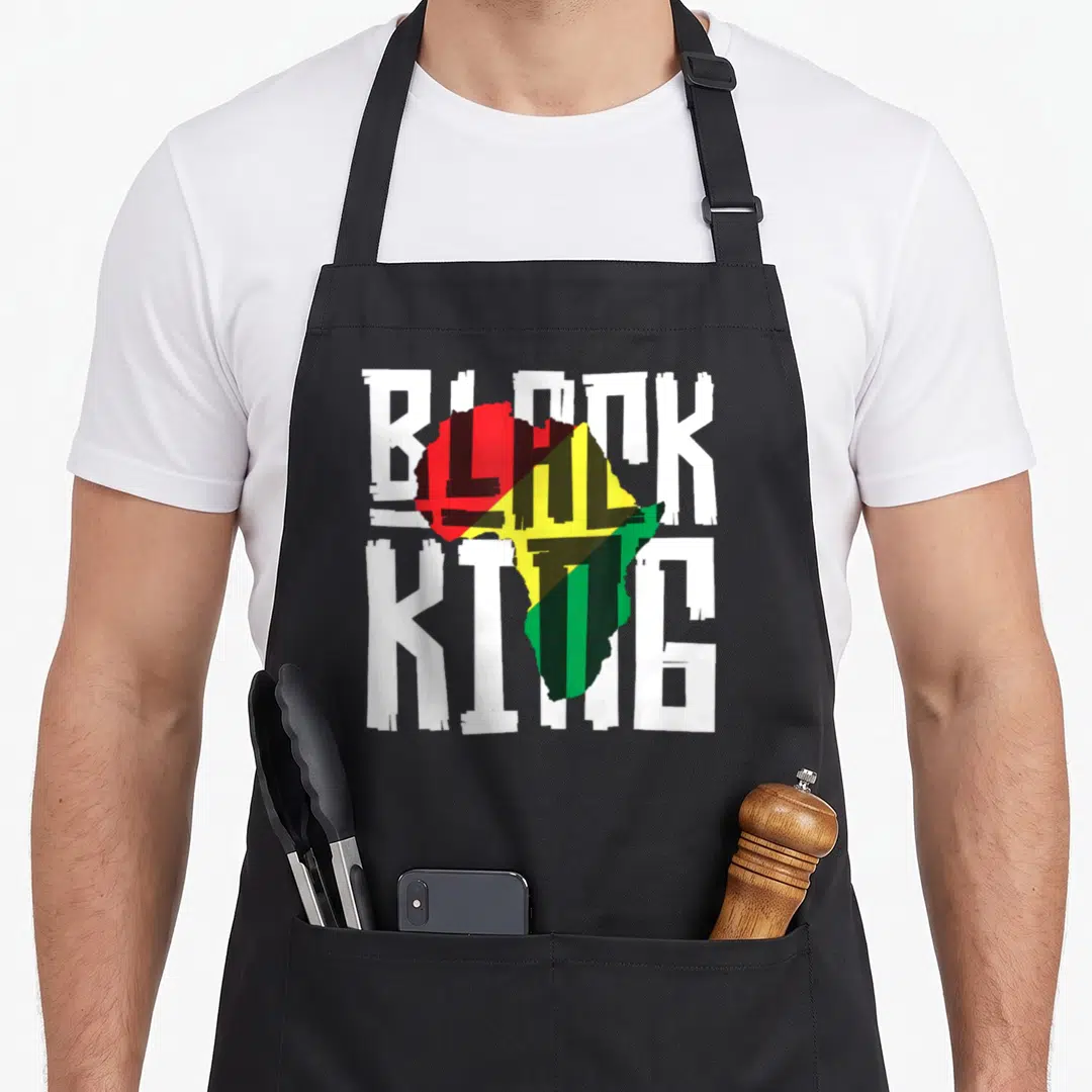 History king apron - Map of Africa in red yellow green black overlaid with white BLACK KING text — shown on a black cotton canvas apron against a white background
