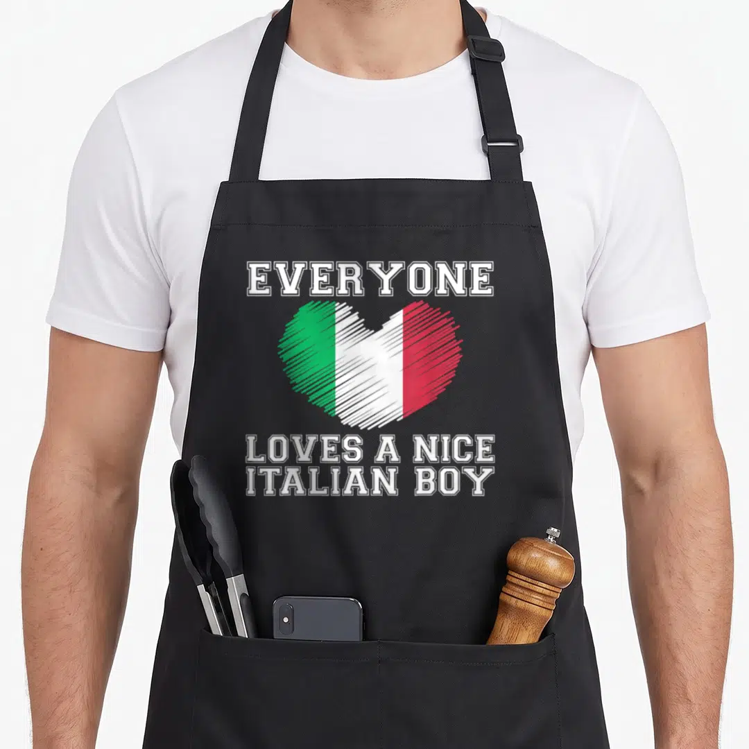 Italian flag italy apron - Heart with white green red stripes and everyone loves a nice italian boy text — shown on a black cotton canvas apron against a white background
