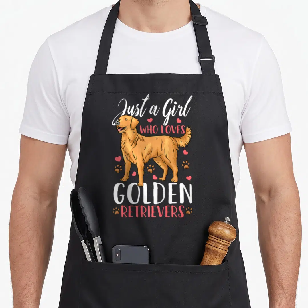 Cute golden retriever apron - Cartoon golden retriever with text Just a Girl Who Loves Golden Retrievers surrounded — shown on a black cotton canvas apron against a white background