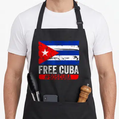 Flag cuba libre apron - Distressed Cuban flag above white text FREE CUBA and #SOSCUBA in a red bar — shown on a black cotton canvas apron against a white background