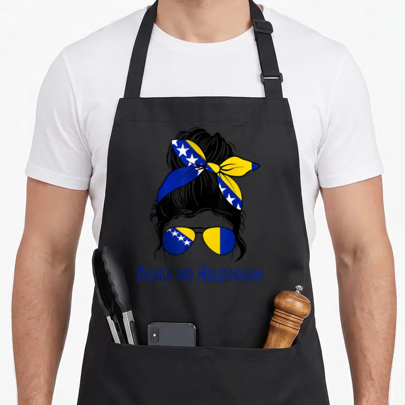 Bosniak bosnian apron - Stylized woman head with flag sunglasses and Bosnia and Herzegovina text in blue yellow black — shown on a black cotton canvas apron against a white background