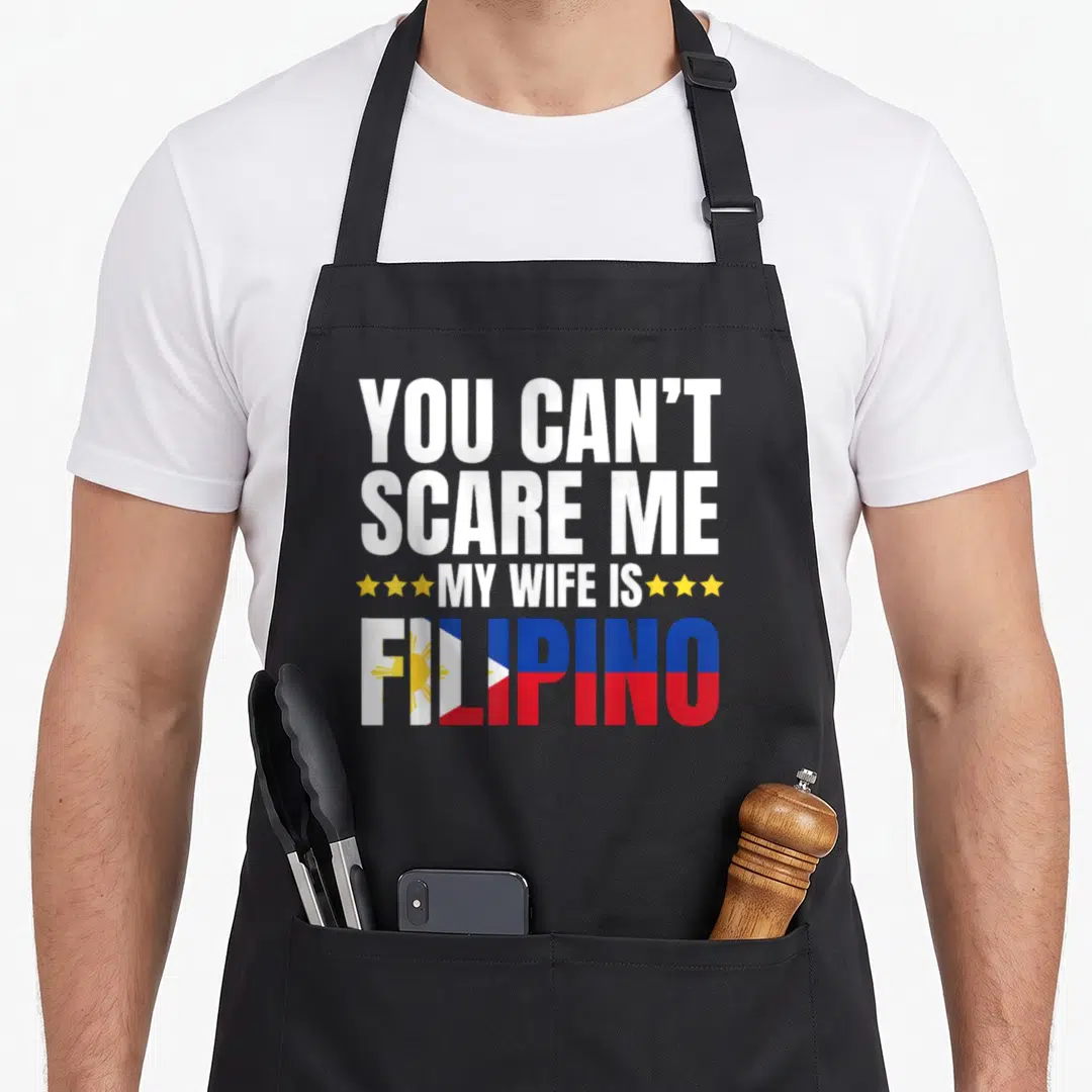 Filipino wife apron - Stacked text with yellow stars and Philippine flag colors filling the bottom word — shown on a black cotton canvas apron against a white background