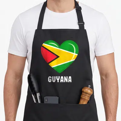 Flag guyanese guyana apron - Heart shaped Guyana flag in green yellow red and white with GUYANA text below — shown on a black cotton canvas apron against a white background