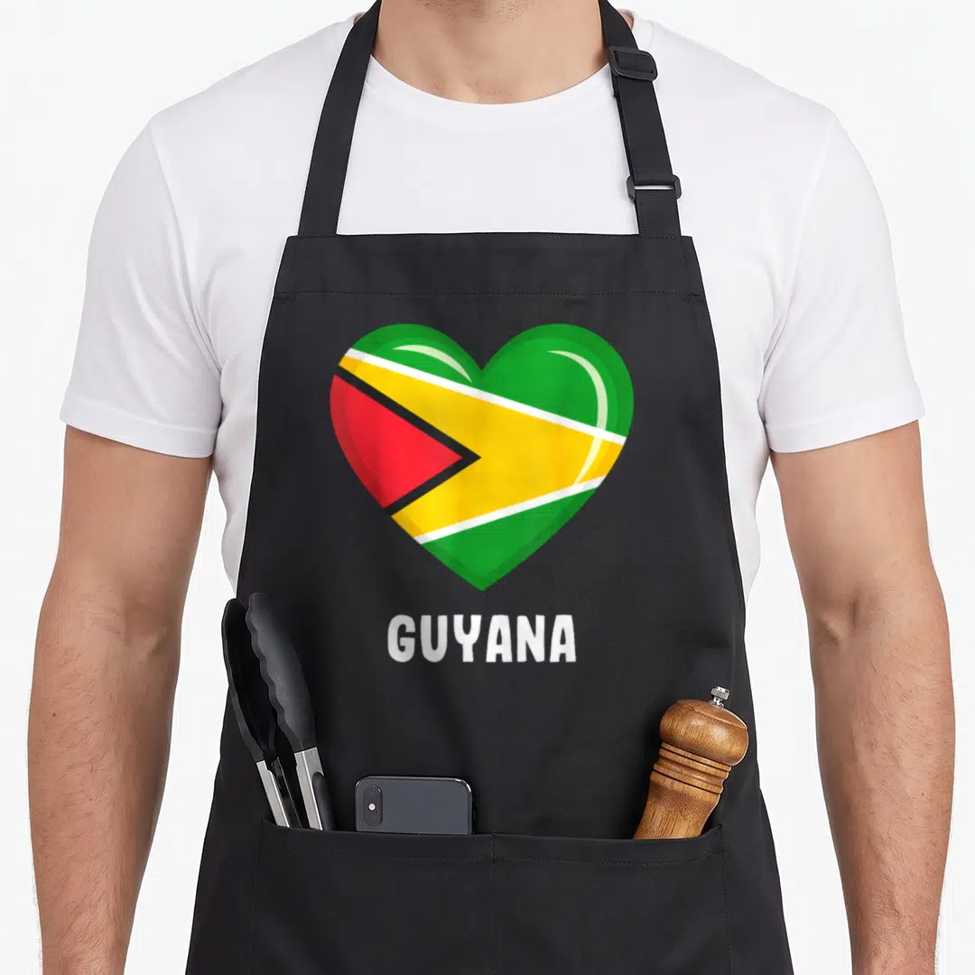 Flag guyanese guyana apron - Heart shaped Guyana flag in green yellow red and white with GUYANA text below — shown on a black cotton canvas apron against a white background