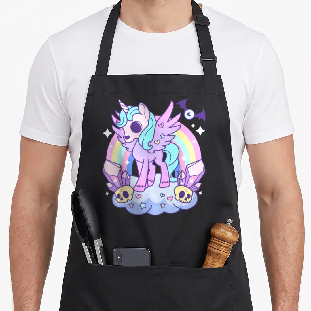 Pony goth apron - Purple alicorn on cloud with rainbow, skulls, crystals, and bat in cartoon style — shown on a black cotton canvas apron against a white background