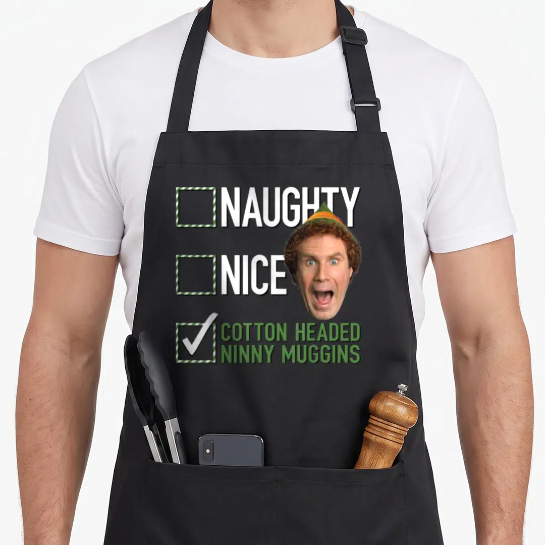 Naughty elf apron - Cartoon man head overlapping three checkboxes labeled naughty nice and cotton headed ninny muggins — shown on a black cotton canvas apron against a white background