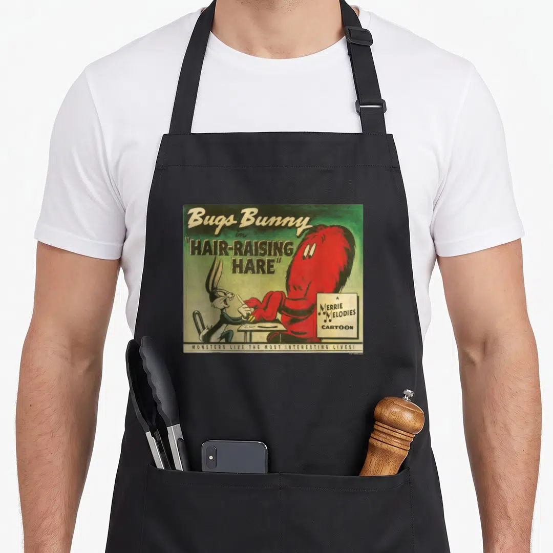 Hair bunny apron - Bugs Bunny and red monster dining under Hair-Raising Hare title text — shown on a black cotton canvas apron against a white background