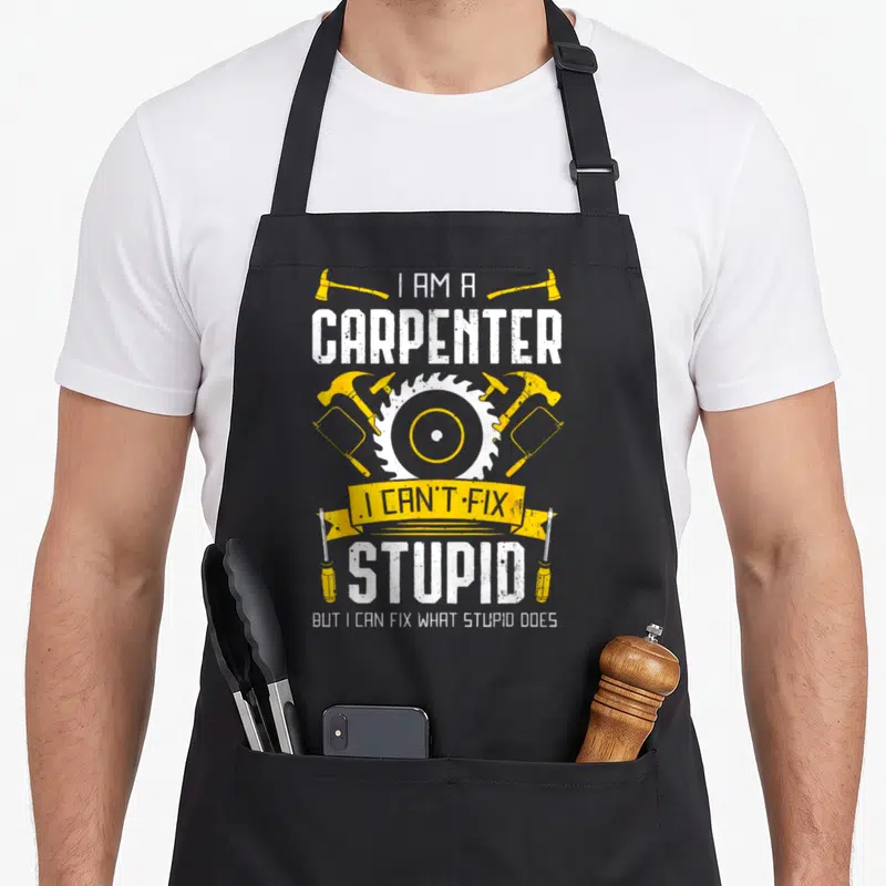 Carving carpentry apron - Circular saw blade and tools with sarcastic carpenter quote in distressed white and yellow — shown on a black cotton canvas apron against a white background