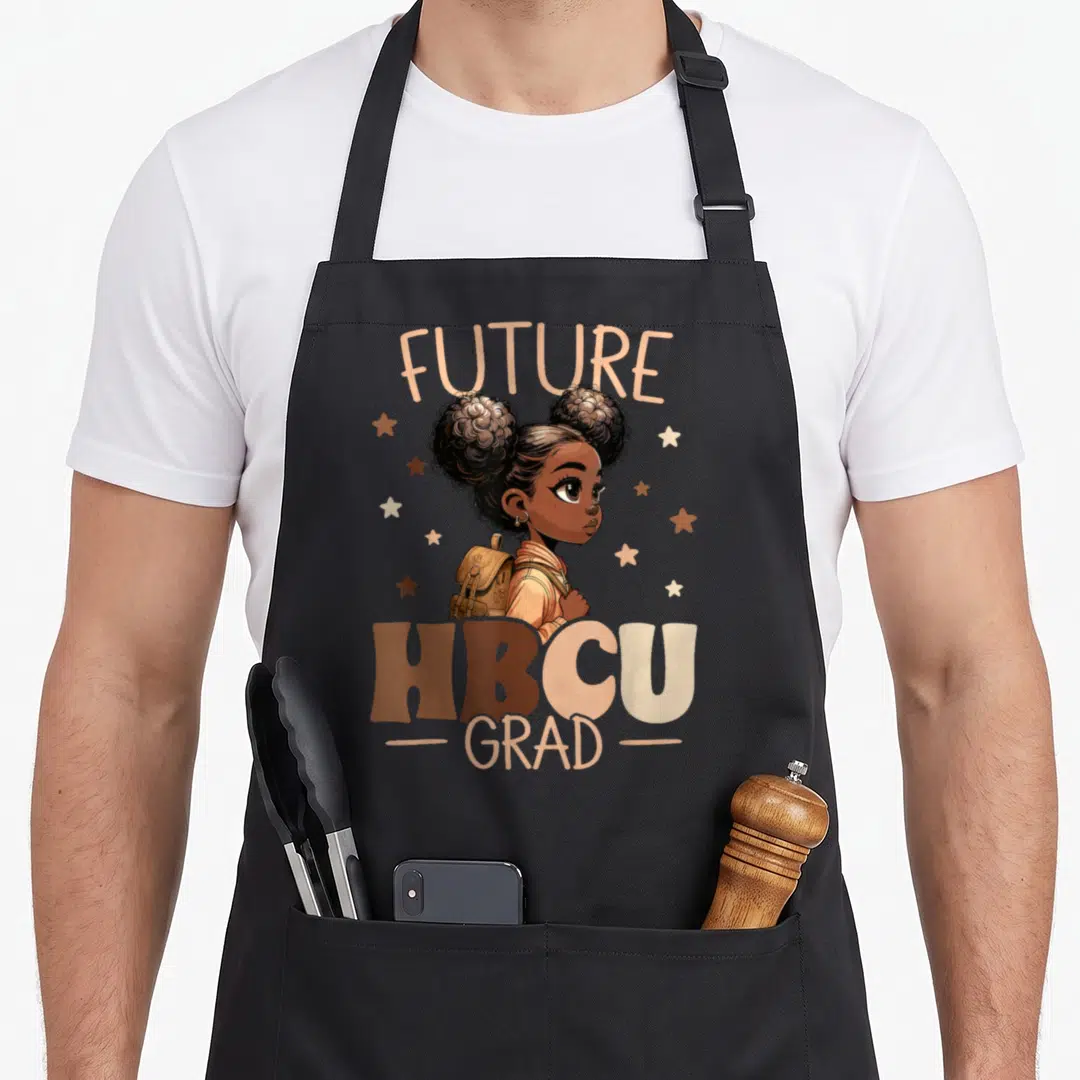 Hbcu college grad apron - Cartoon girl with backpack and stars under FUTURE HBCU GRAD text in earth tones — shown on a black cotton canvas apron against a white background