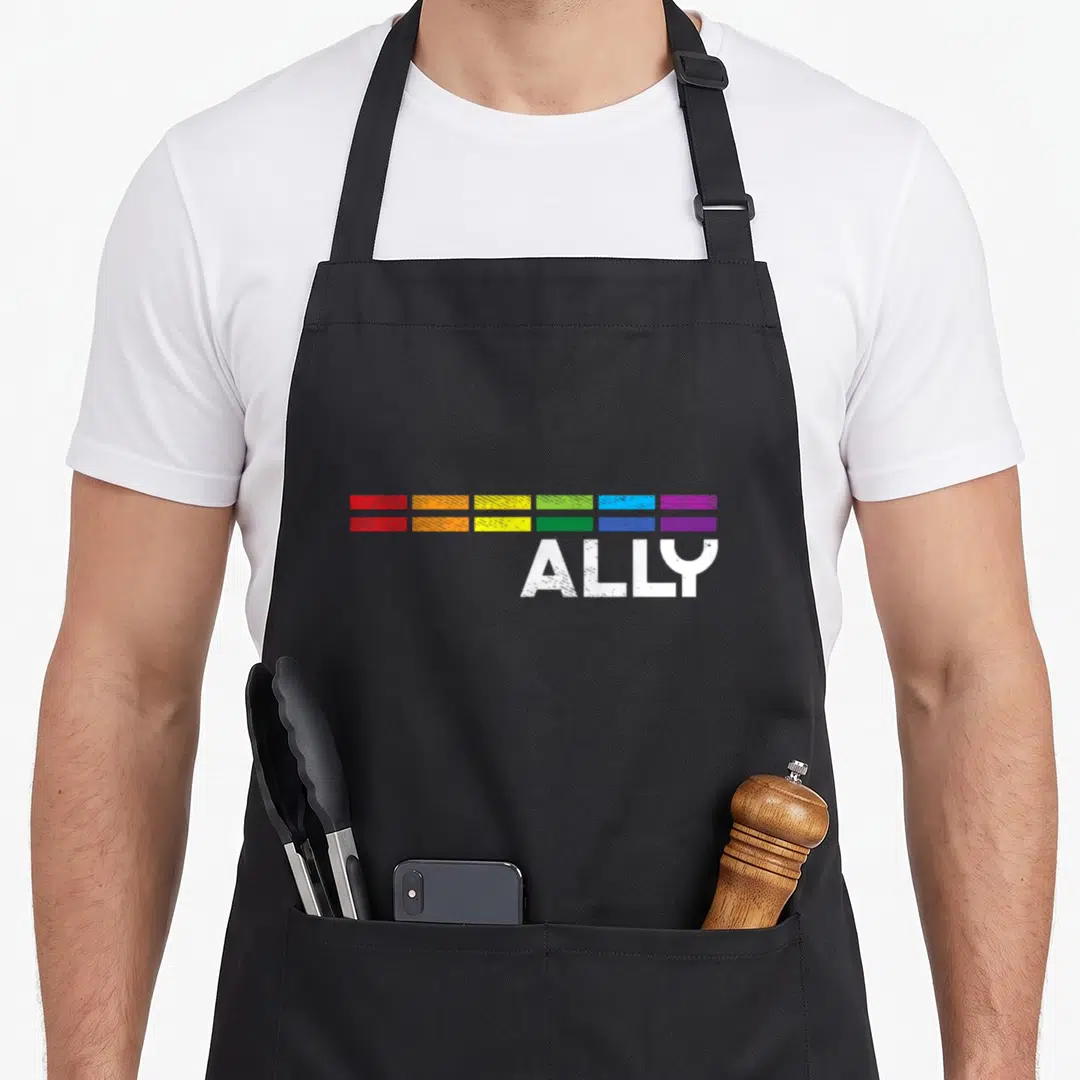 Bar gay pride apron - ALLY text under six rainbow color blocks in two rows — shown on a black cotton canvas apron against a white background