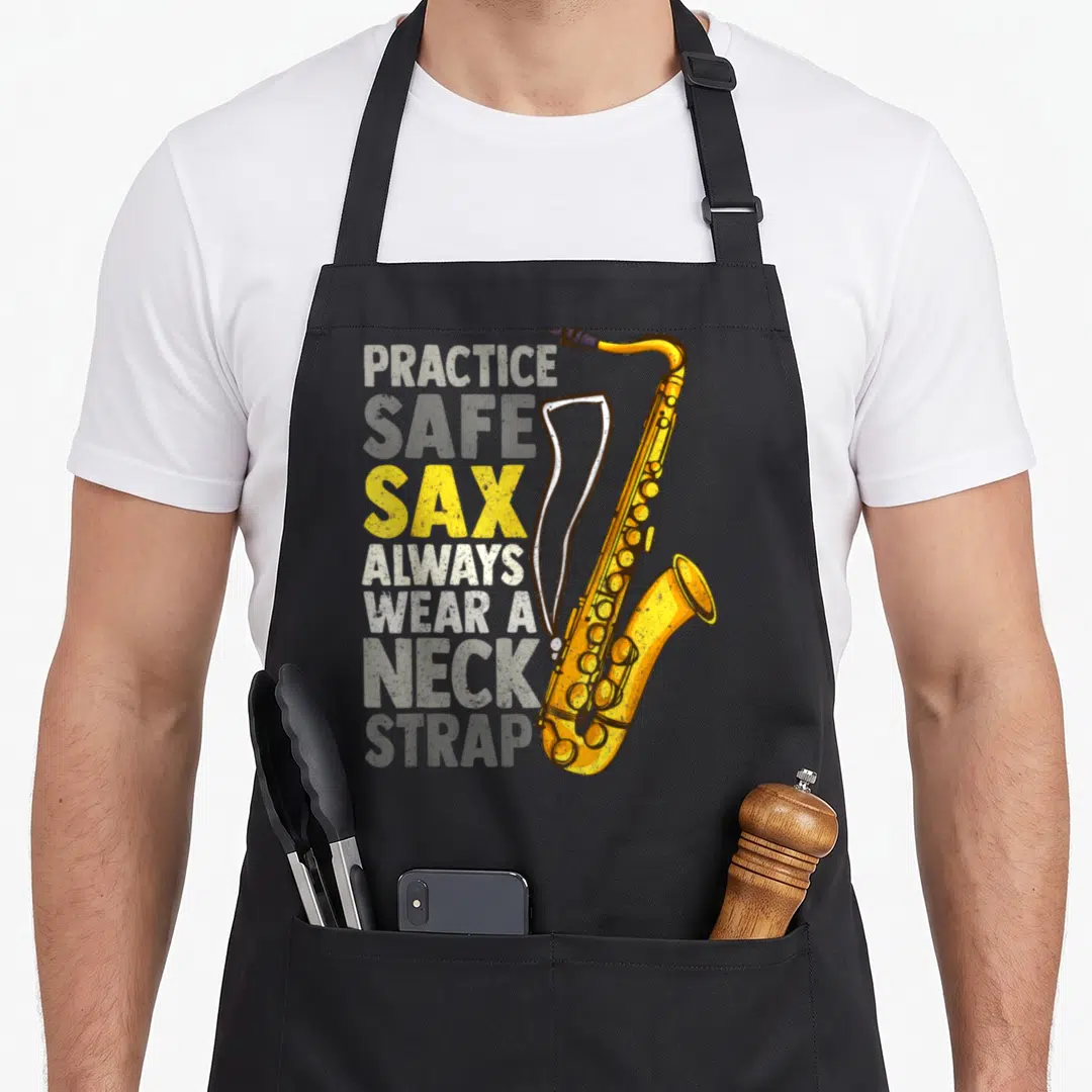 Sax safe apron - Distressed Practice Safe Sax text with yellow saxophone and white neck strap on grey background — shown on a black cotton canvas apron against a white background