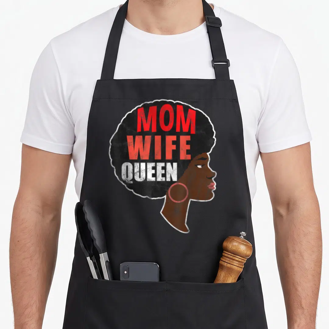 Special mother's day aprons - Cartoon woman profile with black afro containing stacked red and white text reading MOM — shown on a black cotton canvas apron against a white background