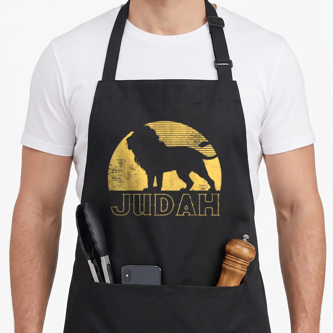 Judah hebrew israelite lions apron - Grey lion silhouette over yellow sun with JUDAH text in distressed style — shown on a black cotton canvas apron against a white background