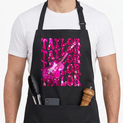 Vintage taylor 80s apron - Pink glitter electric guitar overlaid on five stacked rows of TAYLOR text — shown on a black cotton canvas apron against a white background