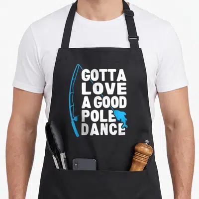 Dance fishing aprons - White stacked text GOTTA LOVE A GOOD POLE DANCE with blue fishing pole and fish — shown on a black cotton canvas apron against a white background