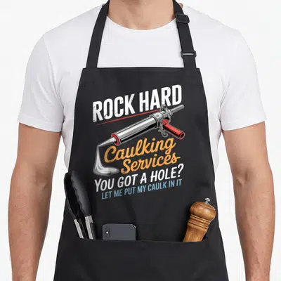Hard service apron - Caulking gun with white caulk and Rock Hard Caulking Services pun text in distressed orange — shown on a black cotton canvas apron against a white background